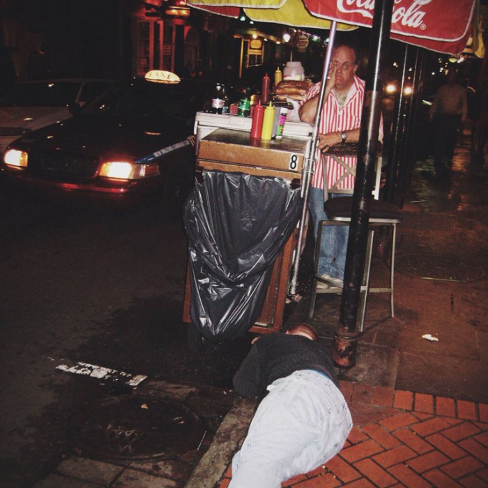 guy passed out face first in front of hot dog stand on bourbon street